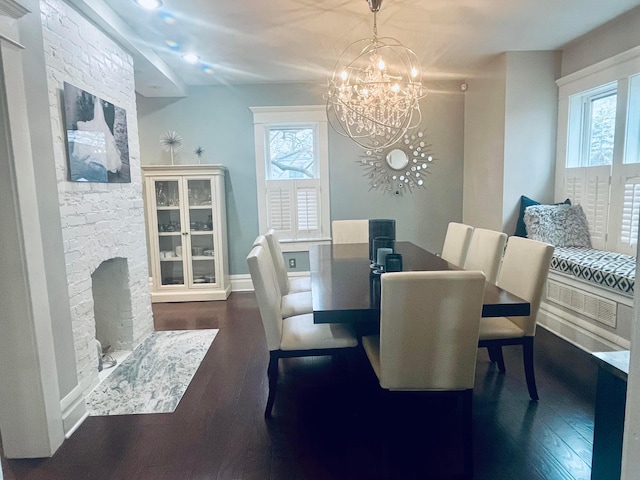 dining room featuring an inviting chandelier, wood finished floors, and a healthy amount of sunlight