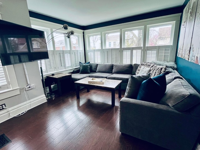 living room with dark wood-type flooring and visible vents