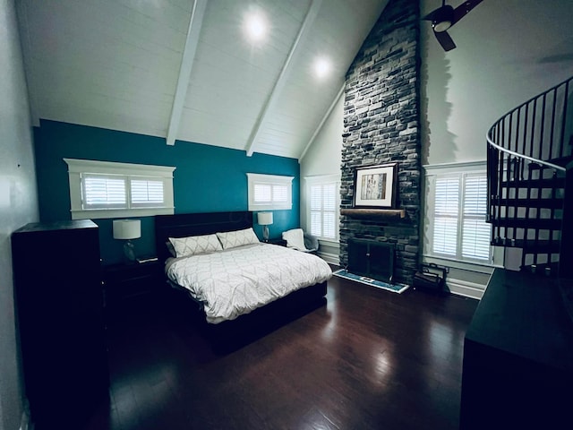 bedroom featuring a fireplace, wood finished floors, high vaulted ceiling, and beamed ceiling