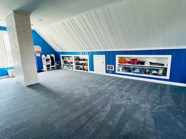 additional living space with carpet floors, decorative columns, vaulted ceiling, and visible vents