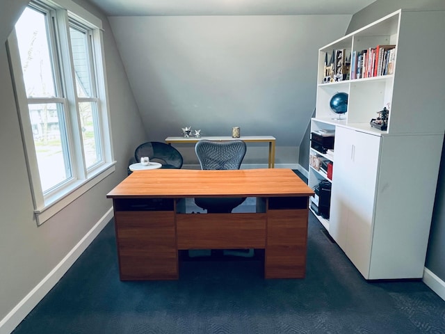 office area with baseboards, plenty of natural light, dark carpet, and lofted ceiling