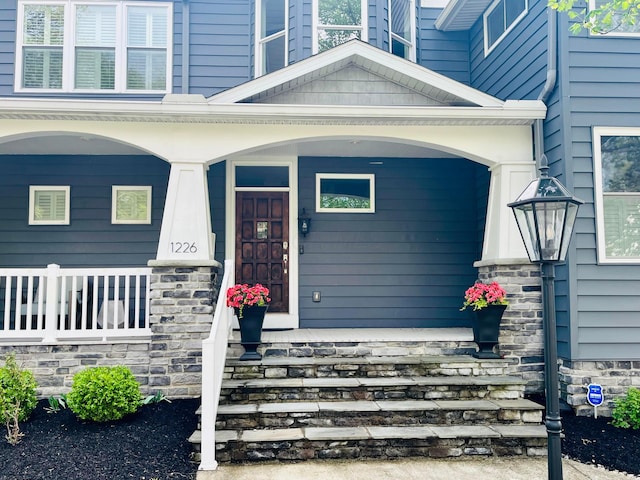 view of exterior entry featuring a porch