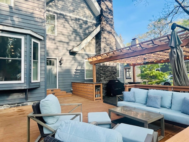 wooden terrace with a pergola, area for grilling, and outdoor lounge area
