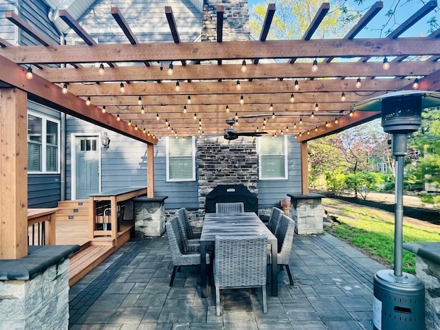 view of patio / terrace with outdoor dining area, a ceiling fan, and a pergola