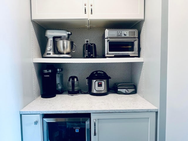 bar with backsplash and beverage cooler