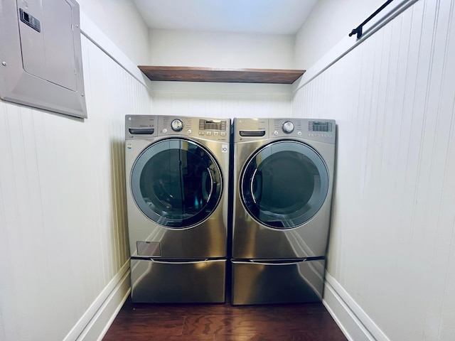 laundry room featuring laundry area, washer and clothes dryer, dark wood-style flooring, and electric panel
