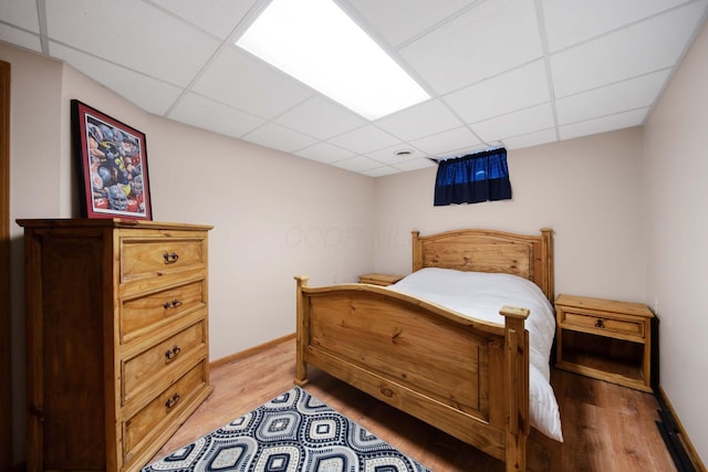 5792 Thada Ln, Columbus, OH 43229 - bedroom featuring light wood-type flooring, baseboards, and a paneled ceiling