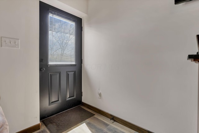 entryway with wood finished floors and baseboards