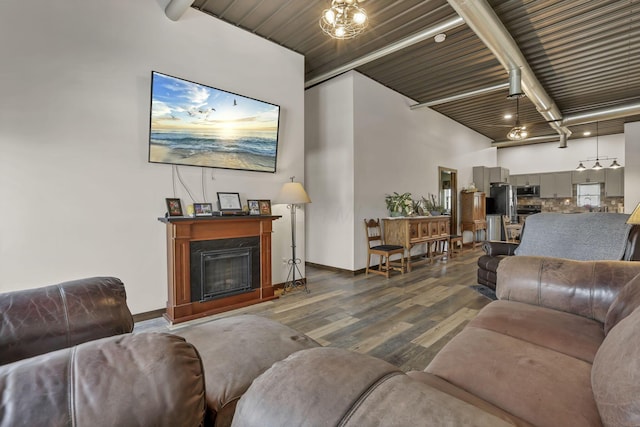 living room featuring beam ceiling, wood finished floors, and wood ceiling