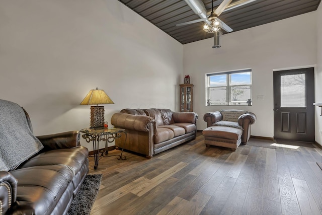 living area featuring wood-type flooring, a ceiling fan, high vaulted ceiling, and baseboards