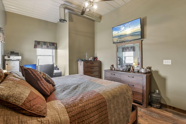 bedroom with wood finished floors, baseboards, visible vents, and multiple windows