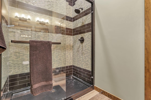 bathroom featuring baseboards and a stall shower