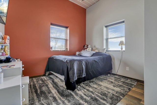 bedroom featuring wood finished floors and baseboards