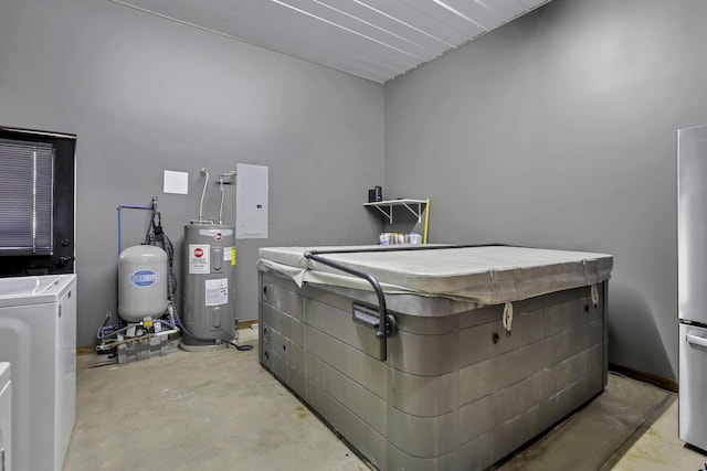 misc room with unfinished concrete floors, washing machine and clothes dryer, electric panel, and electric water heater