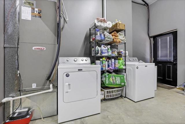 clothes washing area featuring washing machine and clothes dryer and laundry area