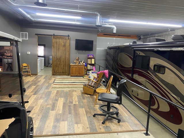 garage with visible vents and washer / dryer