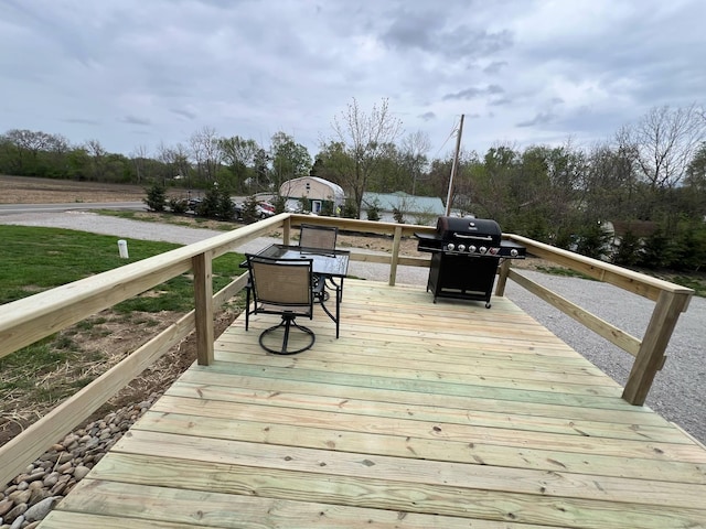 deck featuring outdoor dining area and a grill