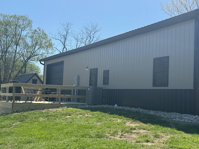 view of home's exterior featuring a yard, central air condition unit, and a wooden deck