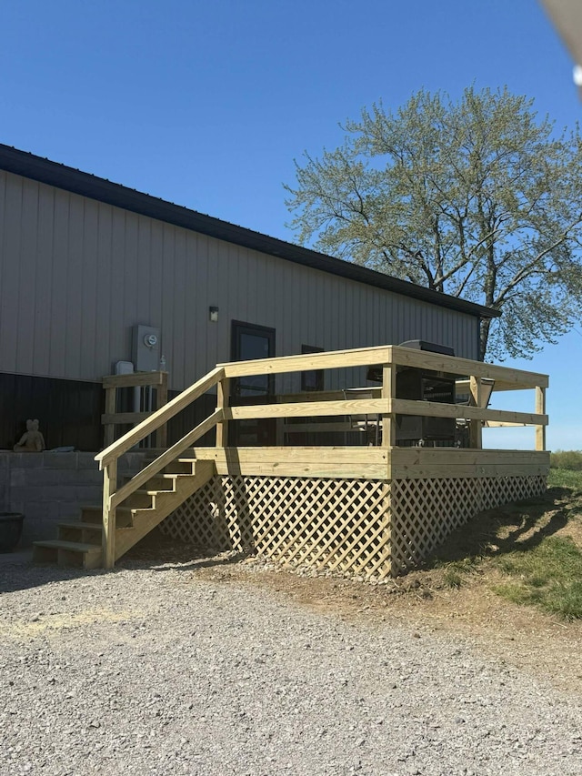 exterior space featuring a wooden deck and stairs