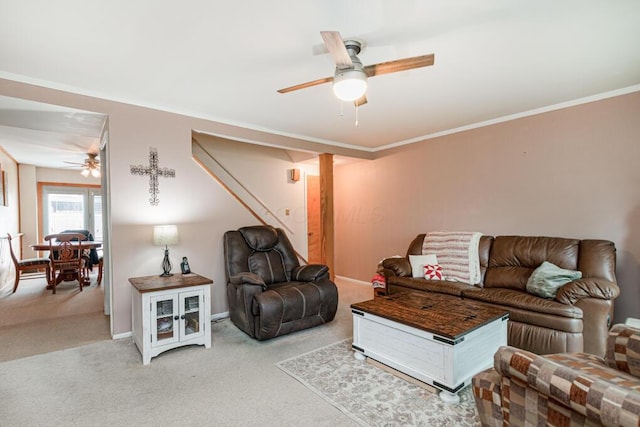 living area with a ceiling fan, carpet flooring, crown molding, and baseboards