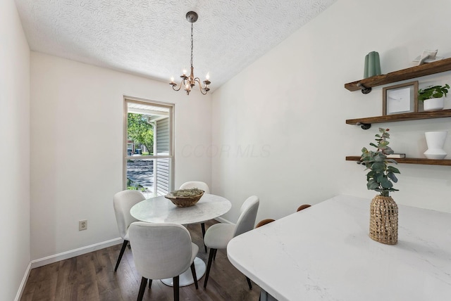 3186 Bowdoin Cir, Columbus, OH 43204 - dining room featuring a chandelier, dark wood finished floors, baseboards, and a textured ceiling