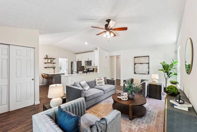 3186 Bowdoin Cir, Columbus, OH 43204 - living room featuring lofted ceiling, ceiling fan, wood finished floors, baseboards, and a textured ceiling