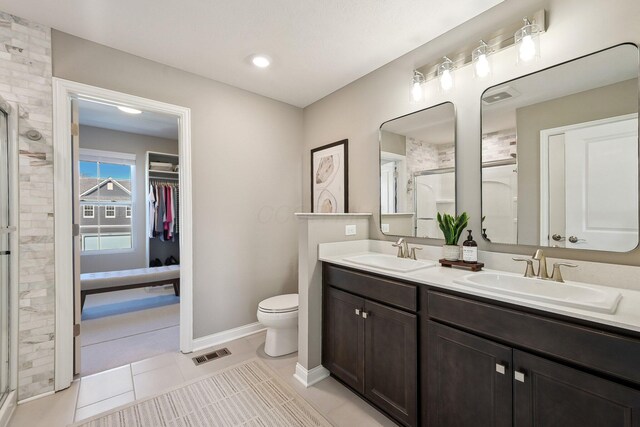 full bath featuring double vanity, visible vents, a sink, and a stall shower