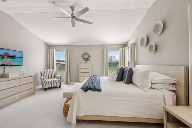 carpeted bedroom featuring a ceiling fan, baseboards, and lofted ceiling