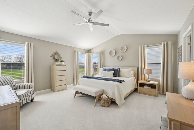 bedroom with ceiling fan, light colored carpet, baseboards, and lofted ceiling