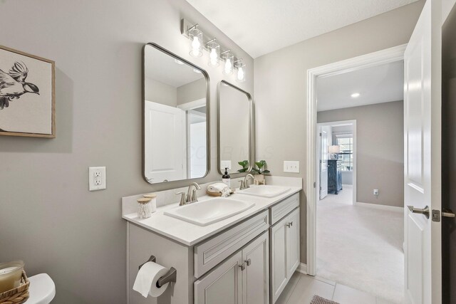 bathroom featuring double vanity, a sink, and tile patterned flooring