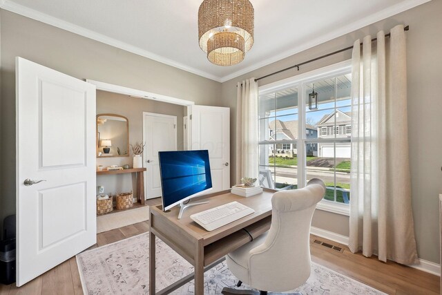 office area featuring visible vents, crown molding, baseboards, an inviting chandelier, and light wood-style flooring