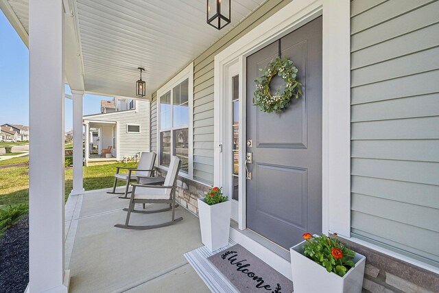 doorway to property featuring covered porch