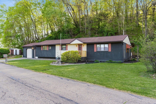 ranch-style house featuring an attached garage, driveway, and a front lawn