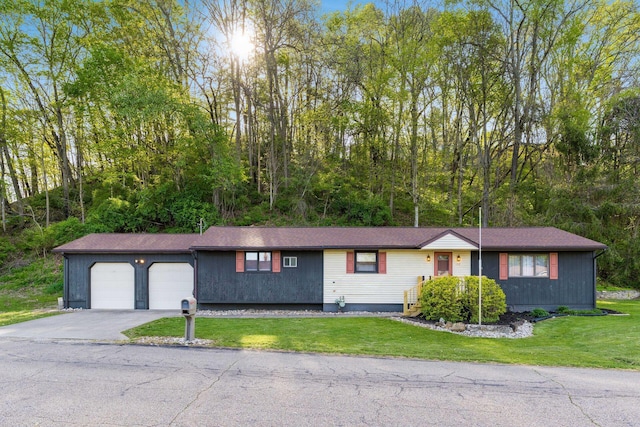 ranch-style home with a garage, driveway, and a front yard