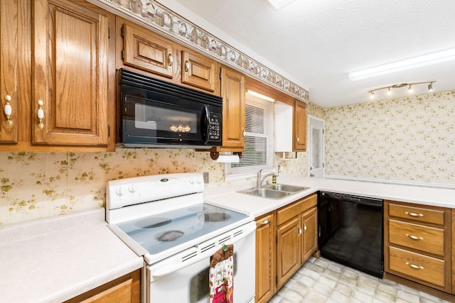 kitchen with wallpapered walls, light countertops, brown cabinets, a sink, and black appliances