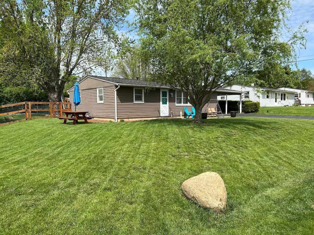 view of front of property with fence and a front yard