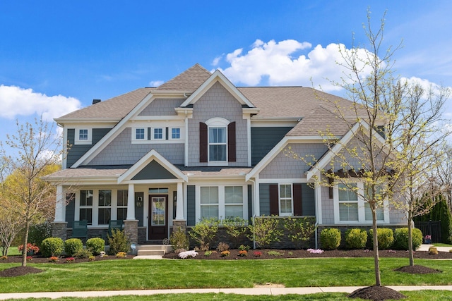 8153 Lilium Way, Plain City, OH 43064 - craftsman house featuring roof with shingles, a front lawn, and stone siding