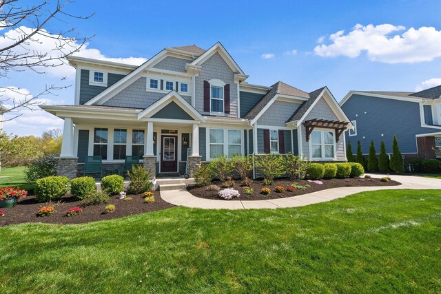 8153 Lilium Way, Plain City, OH 43064 - craftsman inspired home featuring a front yard, stone siding, and a pergola