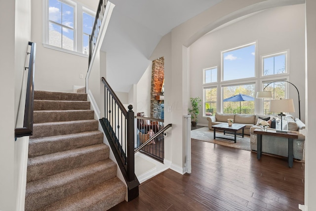 8153 Lilium Way, Plain City, OH 43064 - stairway with a towering ceiling, a healthy amount of sunlight, wood finished floors, and baseboards