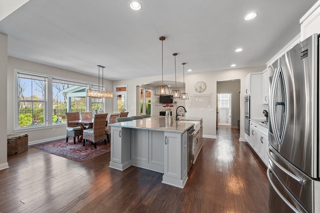 8153 Lilium Way, Plain City, OH 43064 - kitchen with baseboards, white cabinets, an island with sink, and appliances with stainless steel finishes