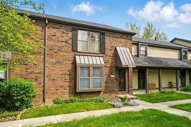 view of property featuring brick siding