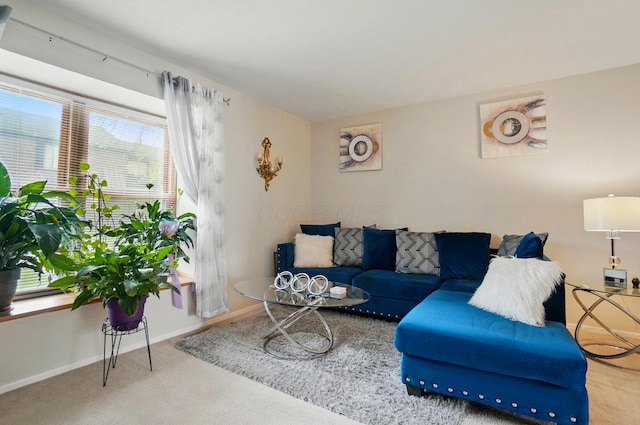 carpeted living room with baseboards and a healthy amount of sunlight