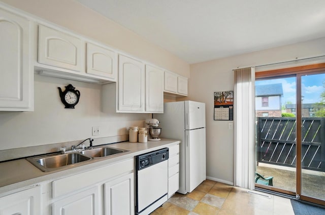 kitchen featuring visible vents, a sink, white cabinets, and white appliances