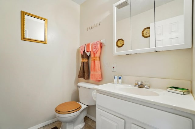 half bath featuring vanity, toilet, and baseboards