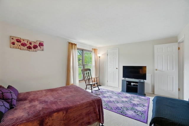 bedroom featuring light carpet