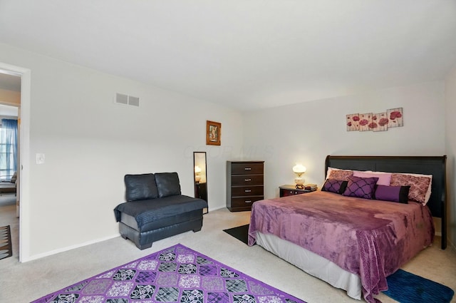 carpeted bedroom with baseboards and visible vents