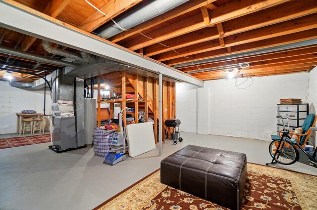 below grade area featuring water heater and heating unit