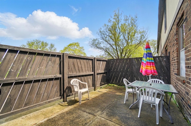 view of patio featuring outdoor dining area and a fenced backyard
