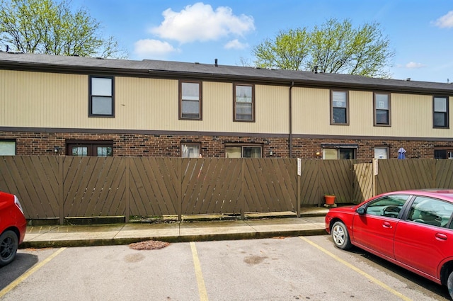 uncovered parking lot featuring a fenced front yard