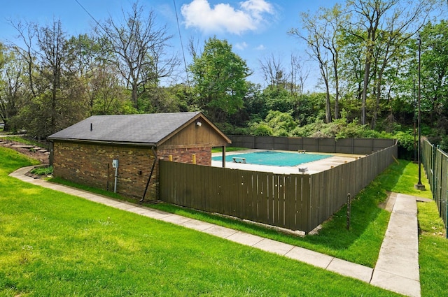 view of swimming pool with fence, a yard, and a fenced in pool